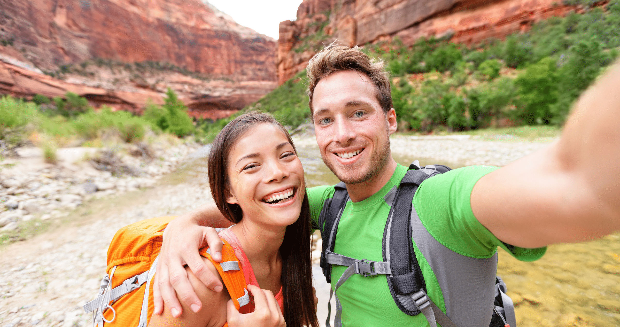 Man and woman taking a selfie while outdoors hiking